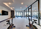 Thumbnail 9 of 80 - A spacious room with exercise bikes and a television.