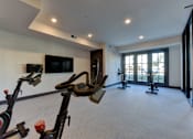Thumbnail 10 of 80 - A room with exercise equipment and a flat screen TV.