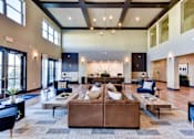 Thumbnail 16 of 80 - A large, open living room with a brown couch and a rug.