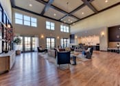Thumbnail 20 of 80 - A spacious living room with wooden floors and furniture.
