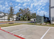 Thumbnail 60 of 80 - A parking lot with a red line on the ground and the letters "EV" painted on the pavement.