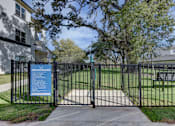 Thumbnail 27 of 80 - A gate with a sign on it in front of a building.