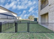 Thumbnail 32 of 80 - A black metal fence in front of a house.