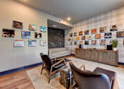 Thumbnail 2 of 80 - A living room with a couch, chairs, and pictures on the wall.