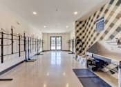 Thumbnail 45 of 80 - A spacious room with a checkered wallpaper and a row of pilates reformers on the left side.