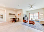 Thumbnail 63 of 80 - A living room with a dining table and chairs.