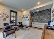 Thumbnail 4 of 80 - A living room with a couch, chairs, and pictures on the wall.