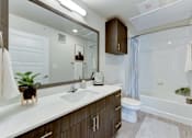 Thumbnail 71 of 80 - A modern bathroom with a white countertop and a white sink.