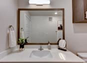 Thumbnail 72 of 80 - A bathroom with a white countertop and a large mirror.