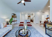 Thumbnail 80 of 80 - A living room with a white couch and a coffee table.