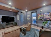 Thumbnail 6 of 80 - A living room with a brown couch and a television.