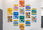 Thumbnail 11 of 15 - A wall of posters with the word "BE A NEIGHBOR" on them.