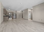 Thumbnail 37 of 39 - A spacious kitchen with light wood flooring and modern appliances.