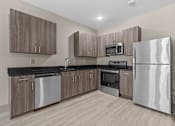 Thumbnail 8 of 39 - A modern kitchen with wooden cabinets and stainless steel appliances.