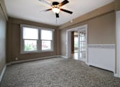 Thumbnail 23 of 66 - Carpeted bedroom with ceiling fan and double doors with glass panes.