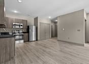 Thumbnail 31 of 39 - A kitchen with wooden cabinets and stainless steel appliances.