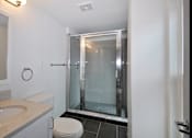 Thumbnail 30 of 66 - Updated modern bathroom with slate tile flooring and standing shower.