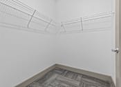 Thumbnail 24 of 39 - A white wall with a metal wire shelf attached to it.