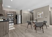 Thumbnail 2 of 39 - A modern kitchen with a dining table set for two.