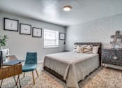 Thumbnail 33 of 57 - A bedroom with a bed, chair, and pictures on the wall.
