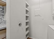 Thumbnail 24 of 40 - A white door with a silver handle is open.
