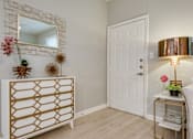 Thumbnail 46 of 57 - A white door is in a room with a gold and white dresser.