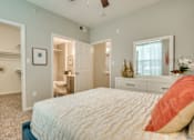 Thumbnail 47 of 57 - A bedroom with a large bed and a dresser with a mirror.