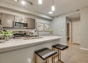 Thumbnail 43 of 57 - A kitchen with a white countertop and a sink.
