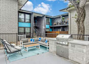 Thumbnail 5 of 57 - A patio with a grill and a chair.