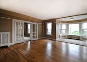 Thumbnail 22 of 66 - Living room with reading nook with large windows and double doors.