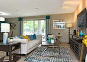 Thumbnail 6 of 18 - a living room with a couch and a table
