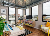 Thumbnail 24 of 47 - a living room with a view of the city and a couch and a television at Ann Arbor City Club, Ann Arbor, 48104