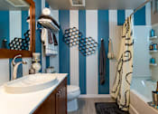 Thumbnail 28 of 47 - a bathroom with blue and white striped walls and a sink and toilet at Ann Arbor City Club, Michigan, 48104