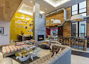 Thumbnail 10 of 47 - a living room with couches and chairs and a fireplace at Ann Arbor City Club, Ann Arbor, 48104
