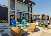 Thumbnail 46 of 47 - a patio area with chairs and tables outside of a building at Ann Arbor City Club, Ann Arbor