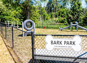 Thumbnail 7 of 17 - a park with a playground and a bark park for residents only