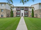Thumbnail 23 of 29 - The image shows a well-maintained lawn in front of a building with the number 8677 on it.
