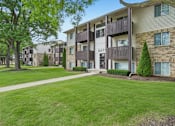 Thumbnail 29 of 29 - Apartment complex with a green lawn in front.