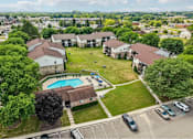 Thumbnail 22 of 29 - A bird's eye view of a residential area with a swimming pool.