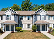 Thumbnail 8 of 17 - a large white house with blue doors and a lawn