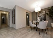 Thumbnail 11 of 18 - a dining room with a table and chairs and a hallway