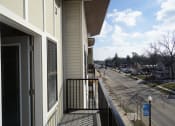 Thumbnail 15 of 18 - a balcony with a view of a street and a house