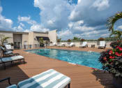 Thumbnail 10 of 22 - Stripped lounge chairs on the sundeck at the Residences of Creeksides rooftop pool.