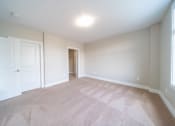 Thumbnail 13 of 22 - Bedroom with plush carpeting, cream  and cream walls.