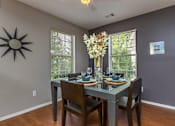 Thumbnail 4 of 26 - a dining room with a table and chairs and a window at Village Club of Farmington Hills, Farmington Hills