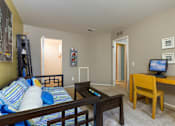 Thumbnail 5 of 26 - a living room with a couch and a television at Village Club of Farmington Hills, Michigan
