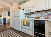 Thumbnail 3 of 20 - a kitchen with a stove microwave and refrigerator at Village Club of Royal Oak, Royal Oak, MI