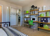 Thumbnail 8 of 20 - a bedroom with a bed and a desk and shelves at Village Club of Royal Oak, Royal Oak