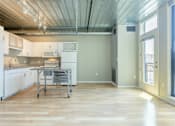 Thumbnail 7 of 47 - a large kitchen with a table in the middle at Ann Arbor City Club, Michigan, 48104