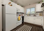 Thumbnail 2 of 20 - a kitchen with white cabinets and a refrigerator at Village Club of Royal Oak, Royal Oak Michigan